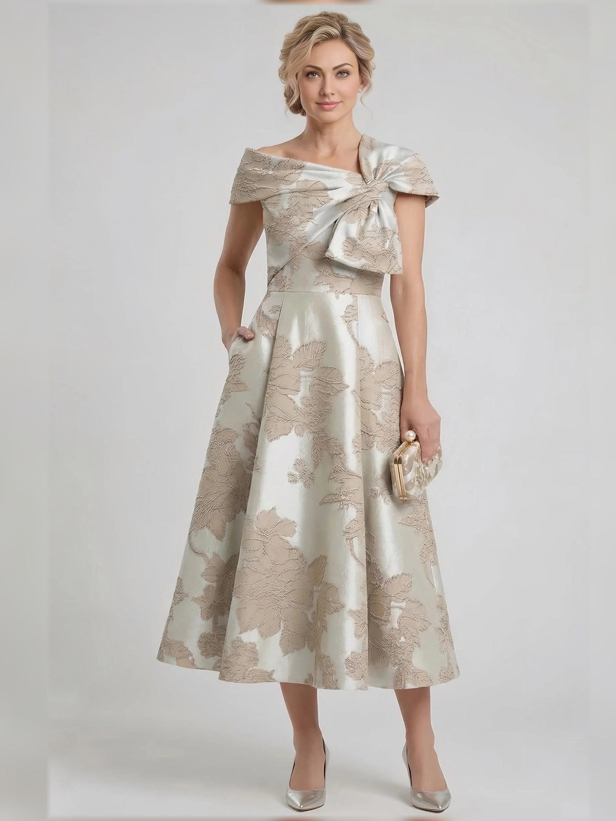 Champagne floral A-line tea-length dress with draped bow at asymmetrical neckline