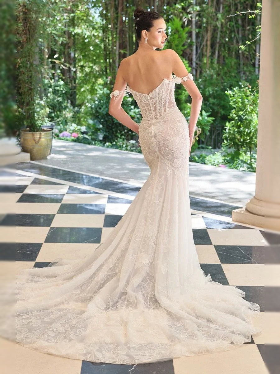 Ivory corset-style wedding dress with lace bodice and V-neck, mermaid tulle skirt, back view