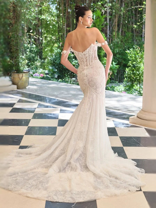 Ivory corset-style wedding dress with lace bodice and V-neck, mermaid tulle skirt, back view