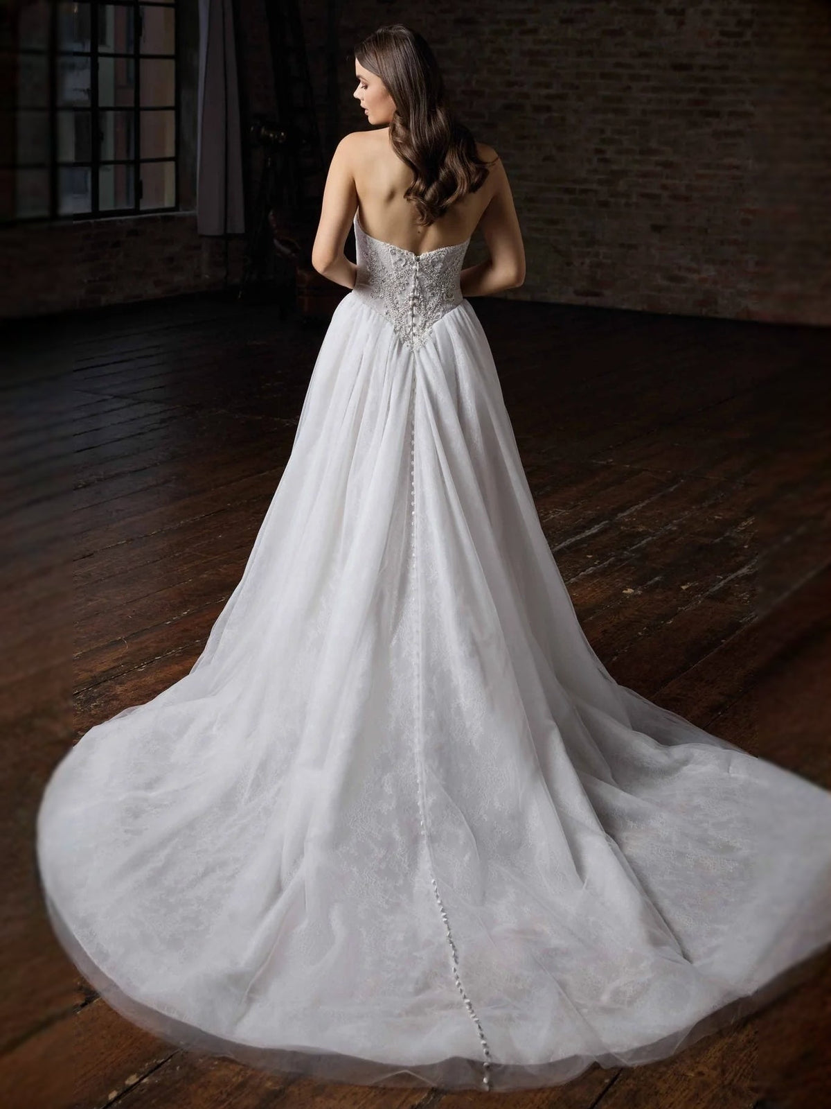 Ivory tulle A-line wedding dress with beaded sweetheart bodice, back view