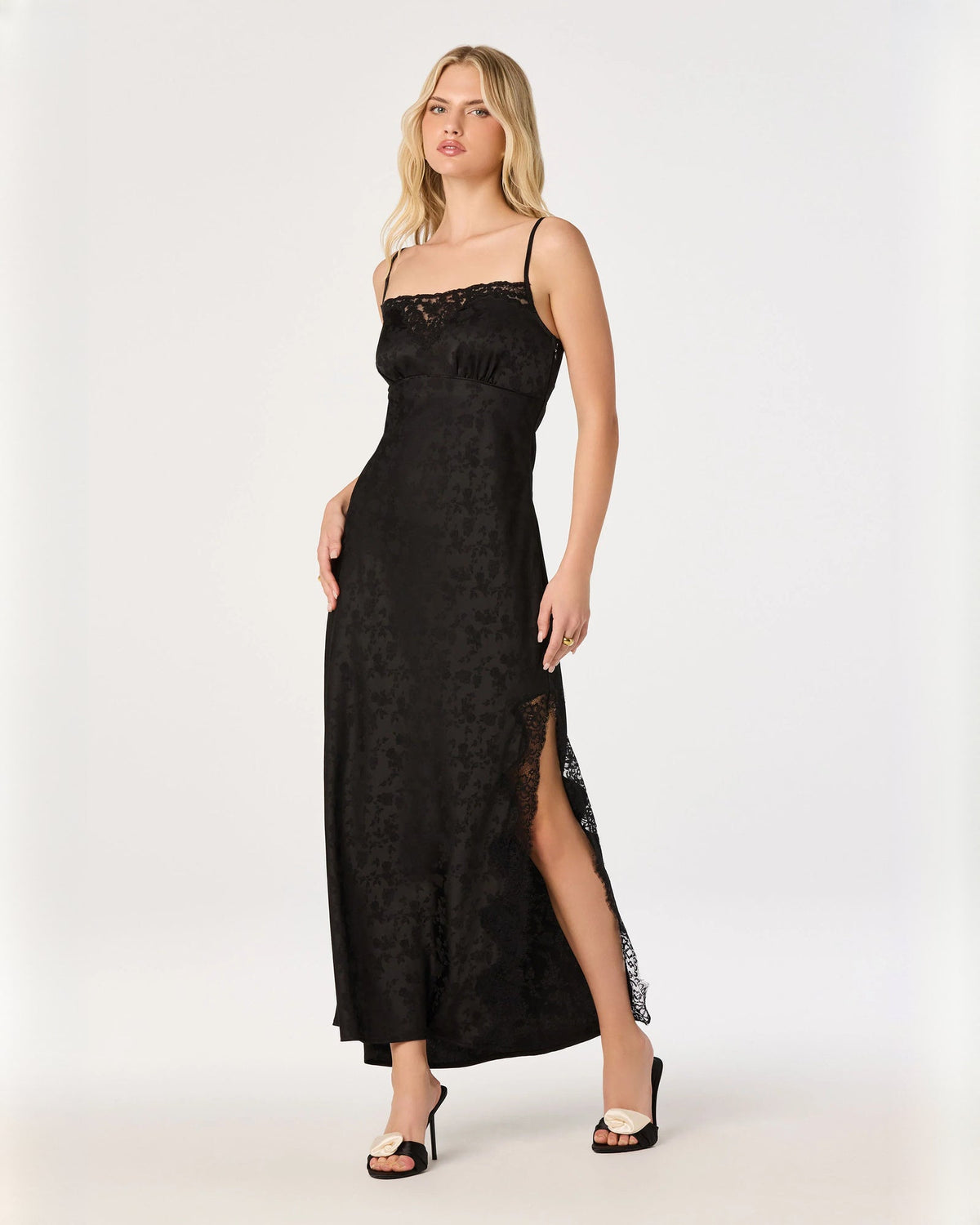 Black sleeveless mesh A-line maxi dress with lace bodice and side slit.