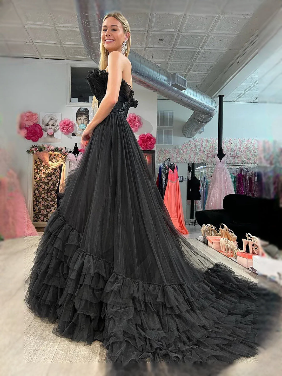 Black sweetheart A-line maxi dress with ruched bodice and layered ruffled tulle skirt.