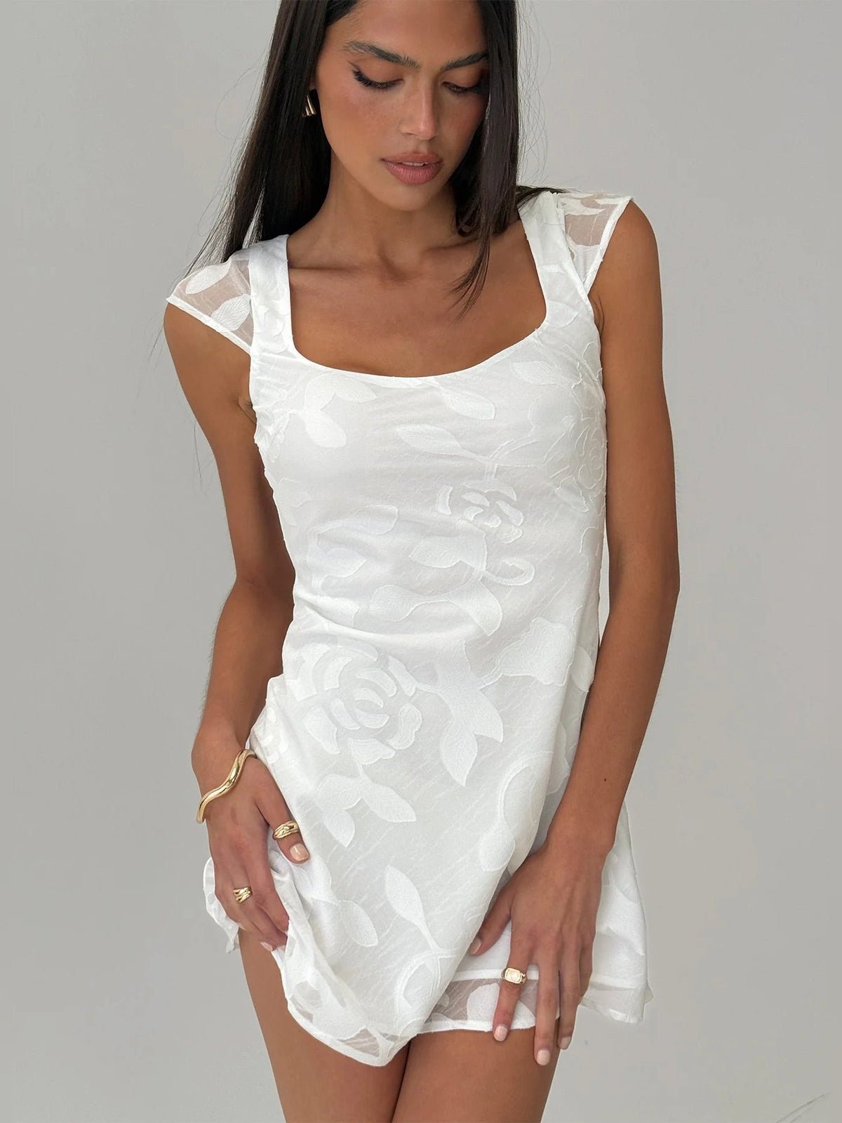 White floral mini dress with square neckline, cap sleeves, fitted waist, flared hem