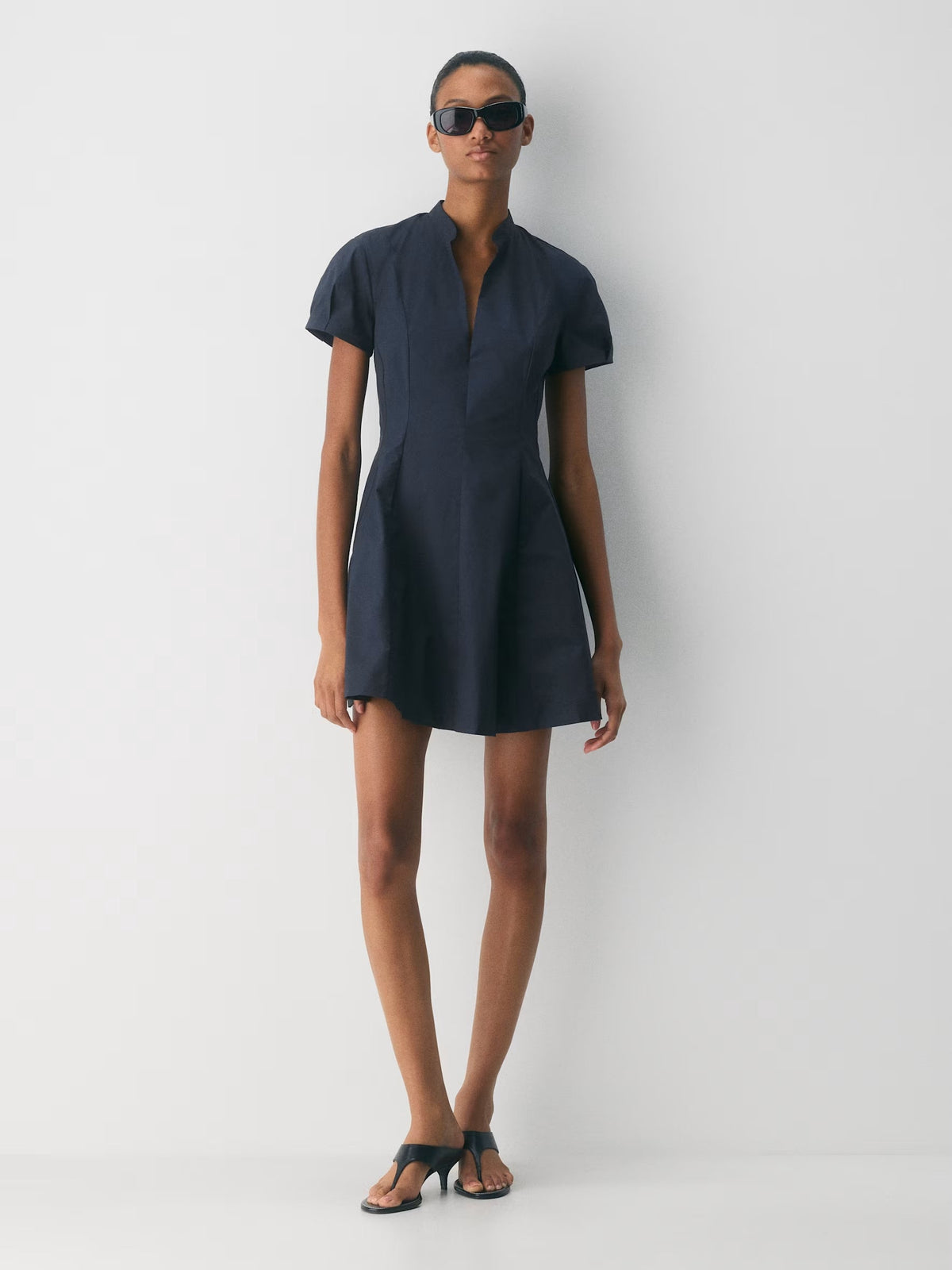 Dark navy A-line mini dress with short sleeves and high neck, front full view