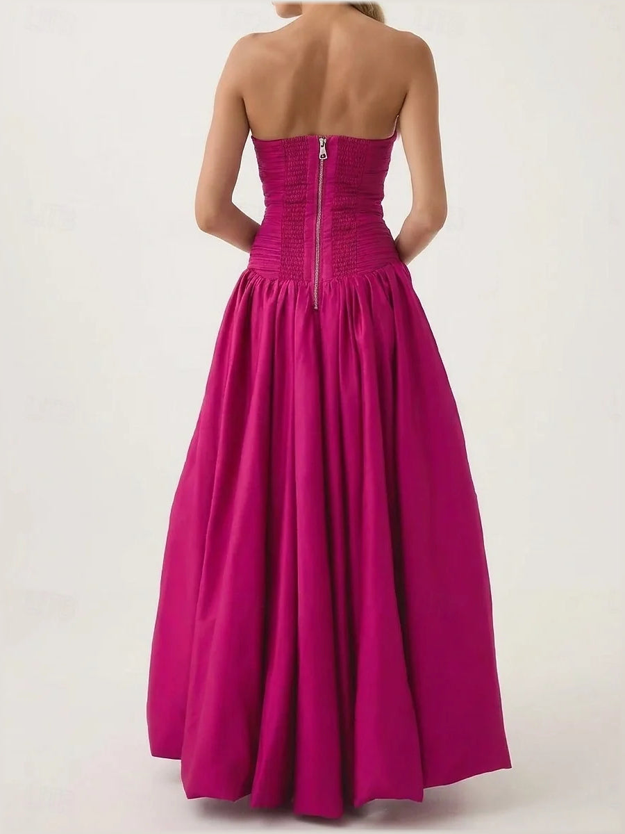 Hot pink strapless maxi prom dress with ruched bodice and gathered A-line skirt