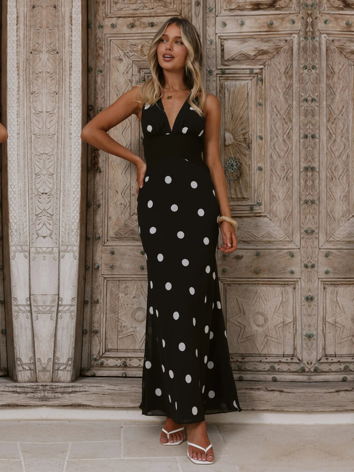 Black White Polka Dot a-line maxi formal dress with halter neckline, full-length front view