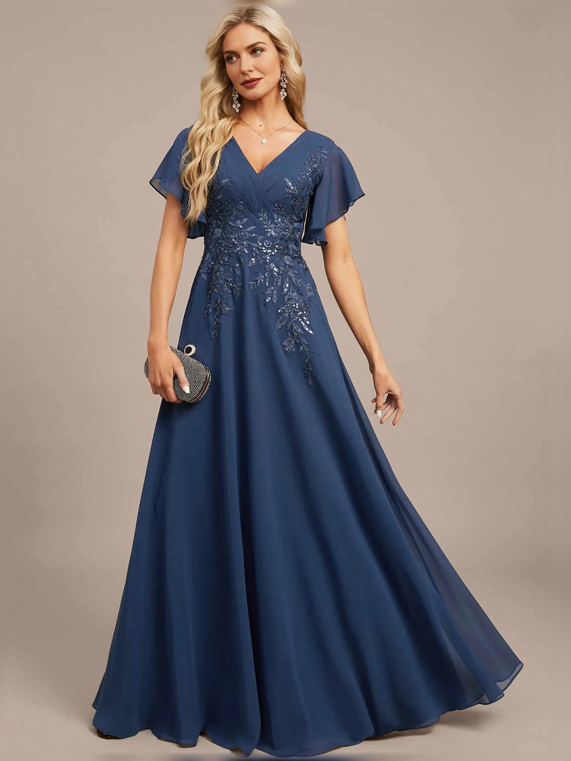 Blue V-neck A-line maxi dress with floral embroidery and pleated chiffon skirt.