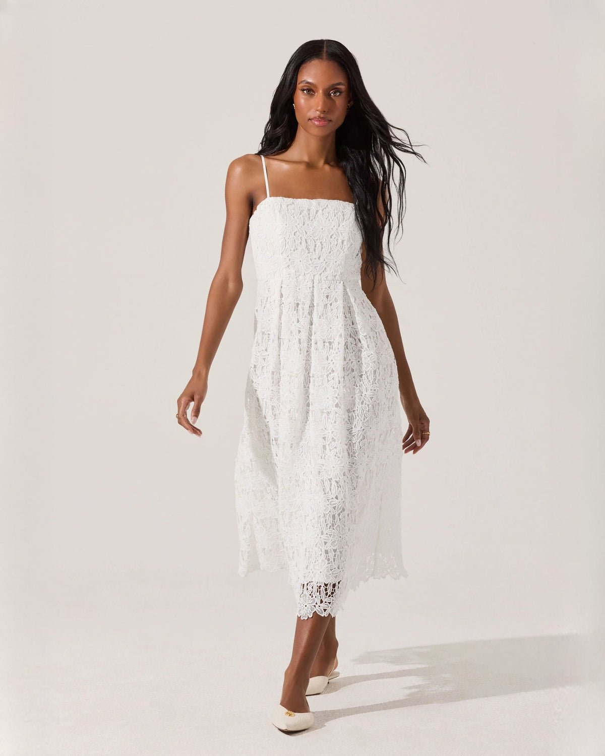 White sleeveless A-line midi dress with spaghetti straps and lace-textured bodice