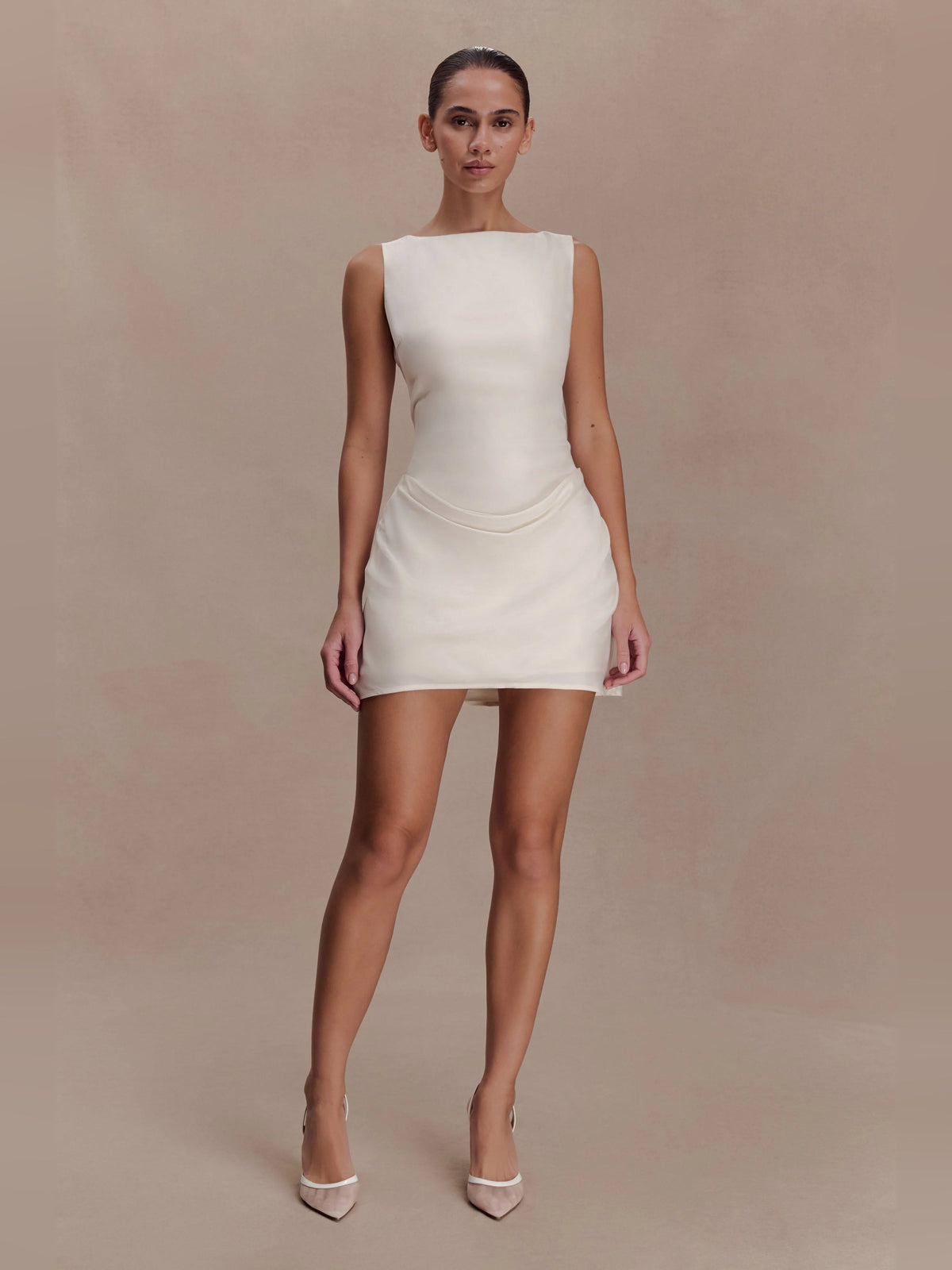 Ivory sleeveless mini homecoming dress with draped cowl detail at waist
