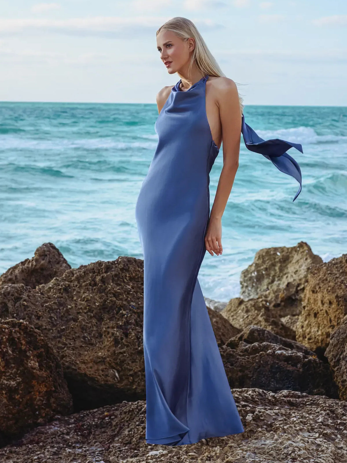 Blue halter mermaid formal dress with open back and floor-length silhouette