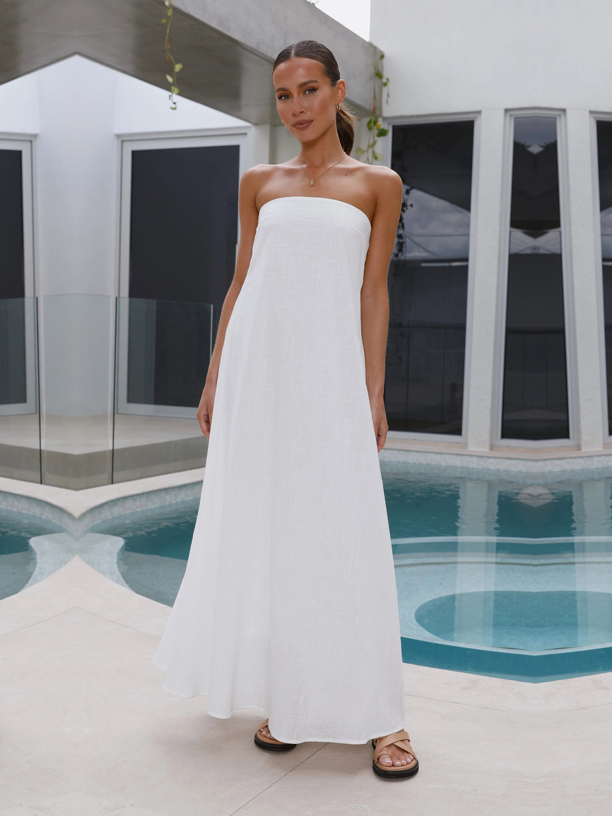White a-line maxi formal dress with strapless neckline, full-length front view