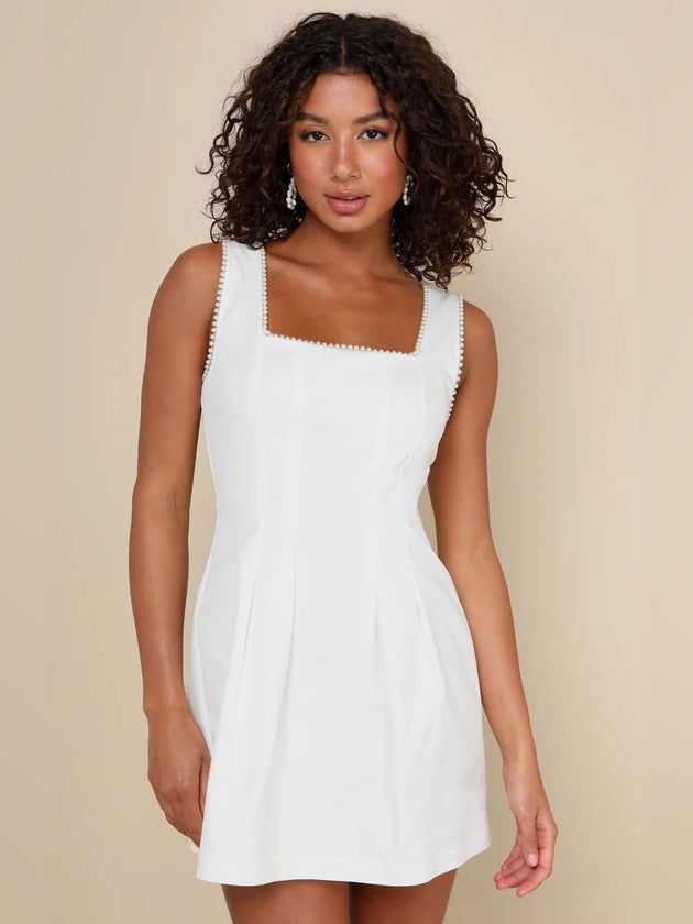 White square-neck mini dress with beaded trim on straps and neckline