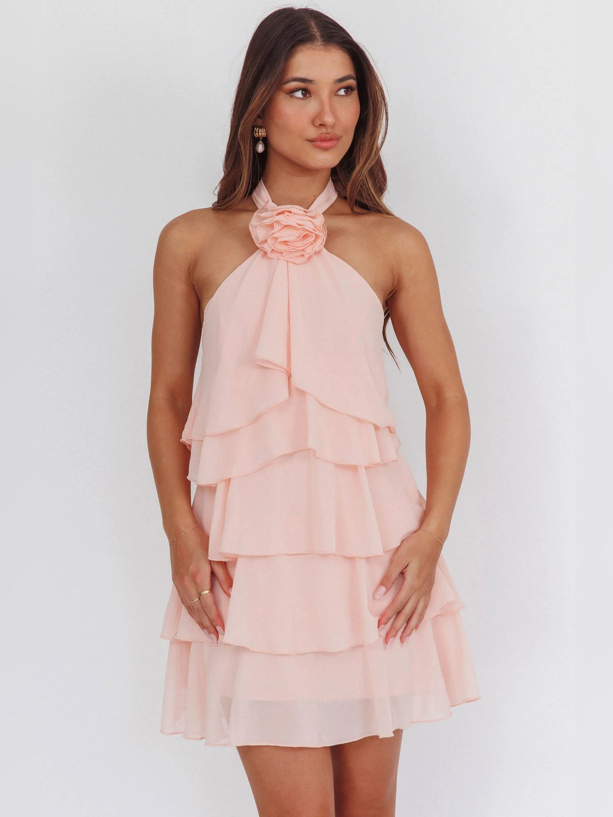 Pink ruffled halter neck mini dress with layered tiers and flower neck detail