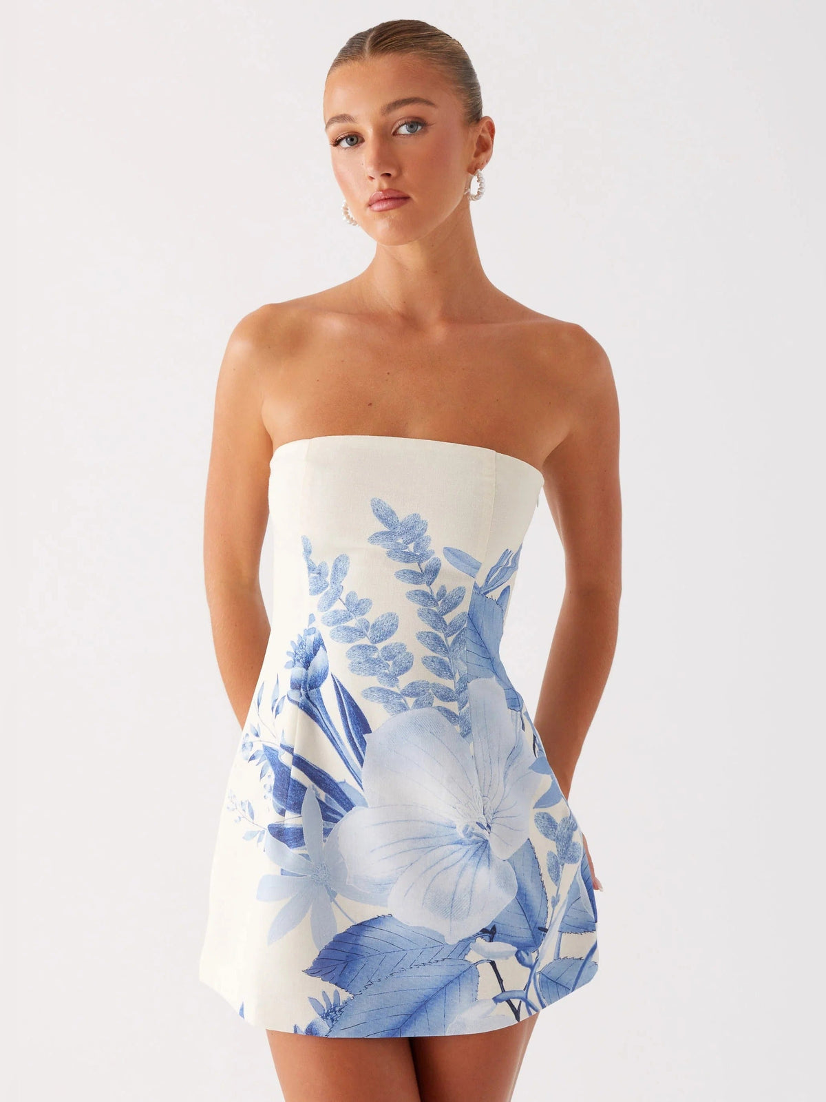 Blue floral strapless mini homecoming dress with cinched waist and A-line skirt