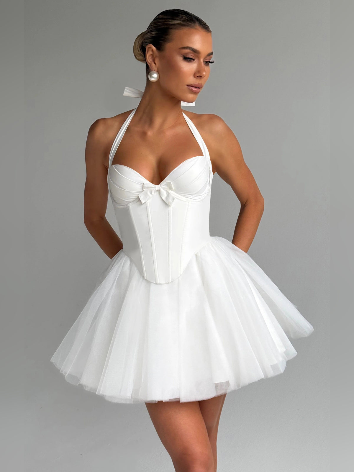 Ivory mini homecoming dress with halter bow bodice and tiered tulle skirt