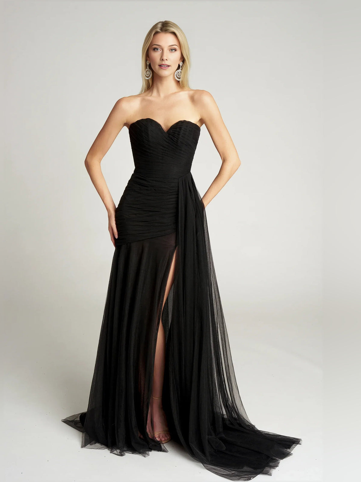 Black strapless sweetheart draped mermaid formal dress with side slit and tulle hem.