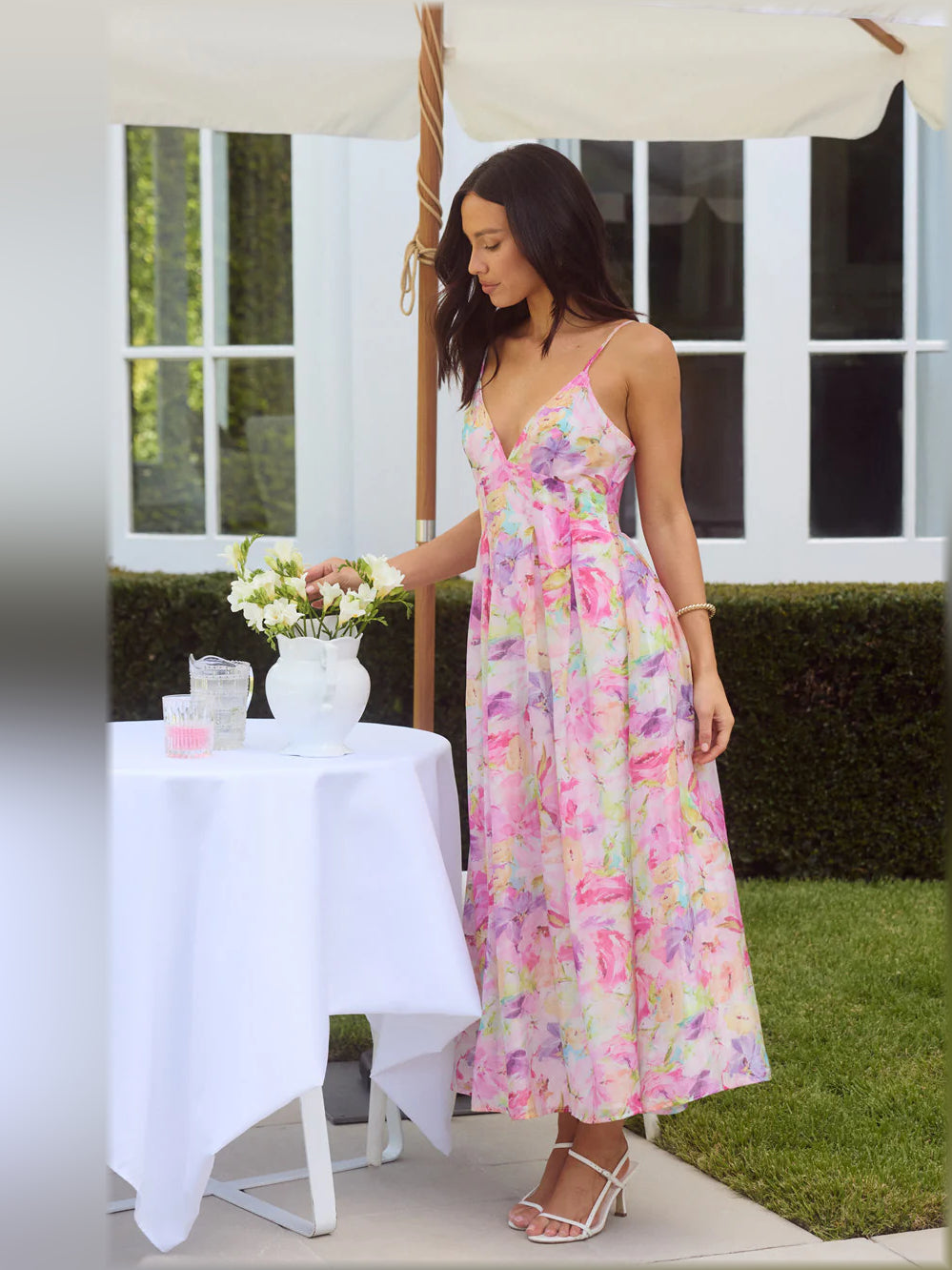 Multicolor floral print midi dress with spaghetti straps, V-neck, and flared tiered skirt