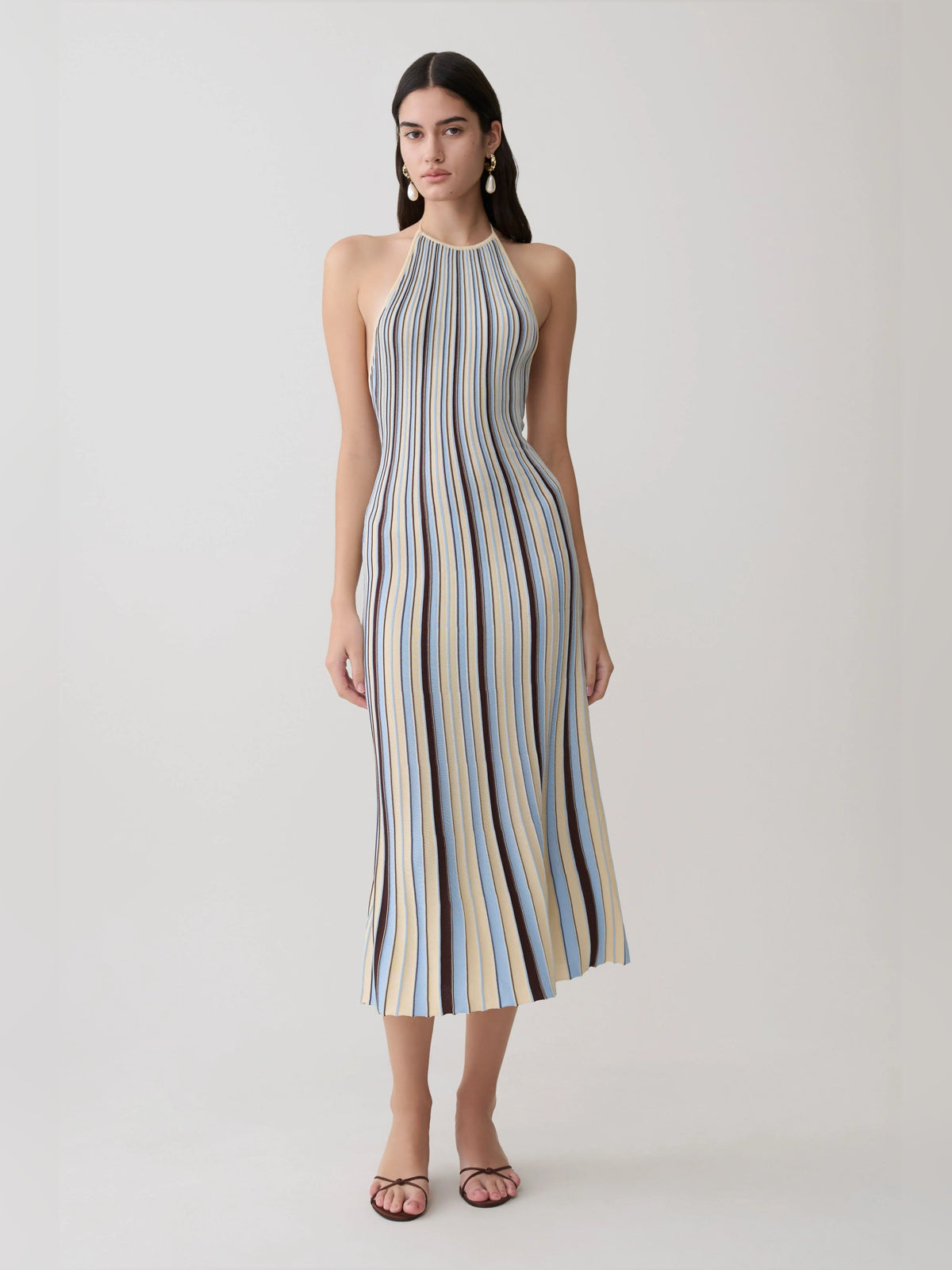 Halterneck knit midi formal dress with vertical stripe pattern in cream, blue, and brown.