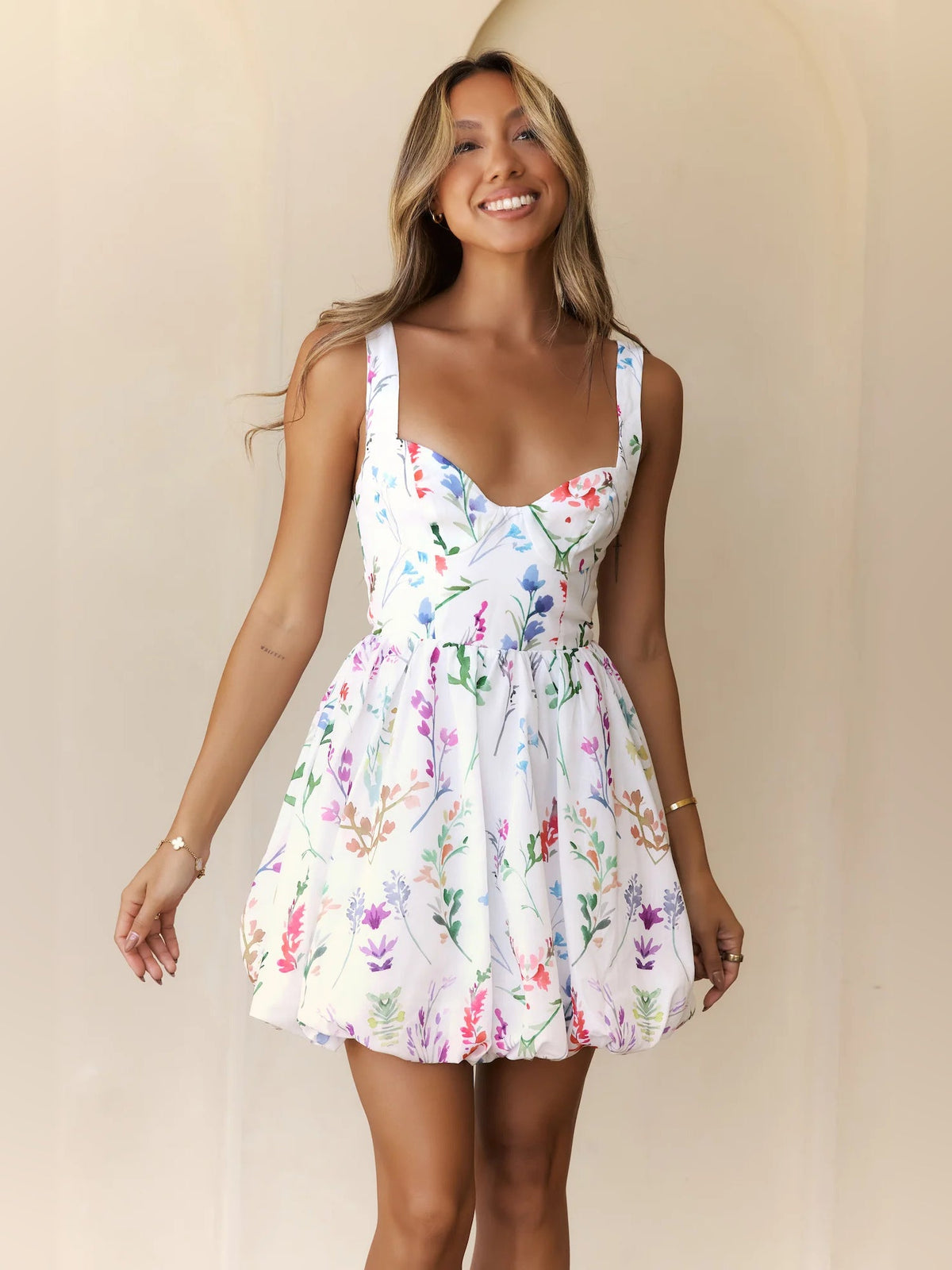 White floral mini dress with spaghetti straps and sweetheart bodice