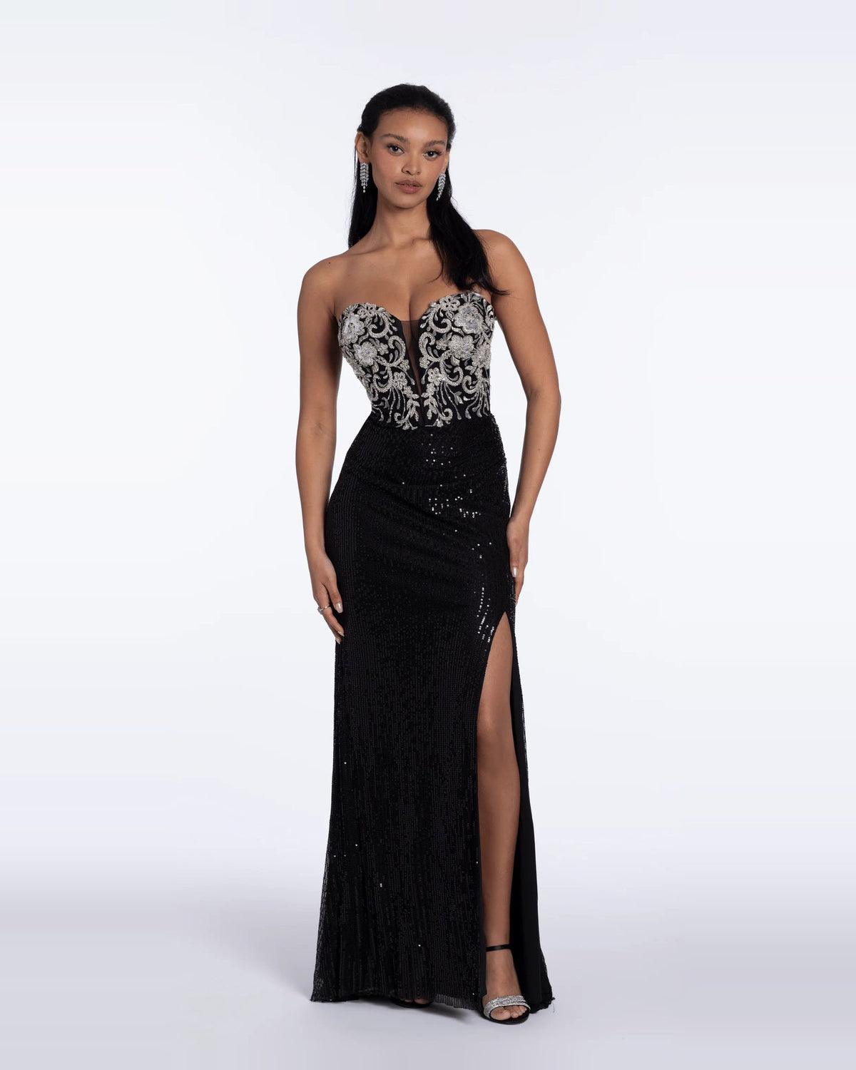 Black strapless maxi prom dress with silver patterned bodice and side slit.