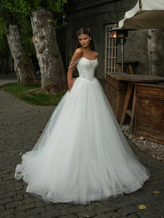 Ivory sweetheart corset ball-gown with lace bodice and layered tulle skirt
