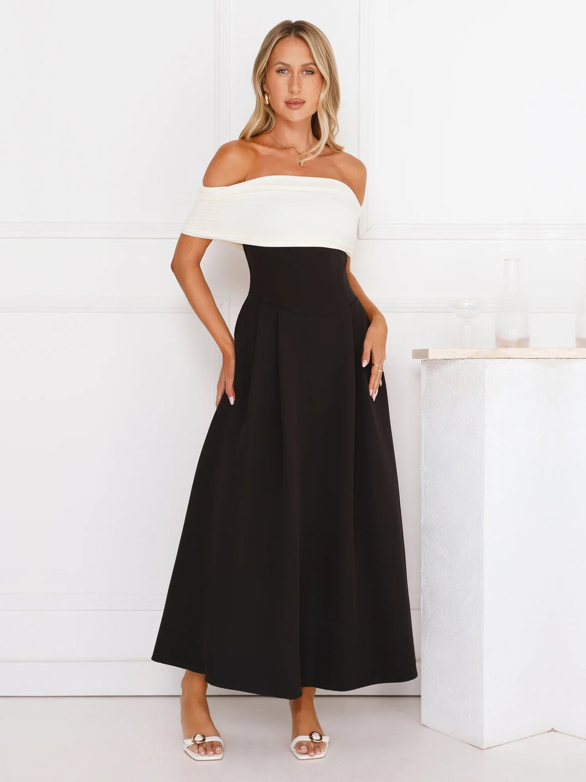 Black a-line maxi formal dress with off-the-shoulder neckline, full-length front view