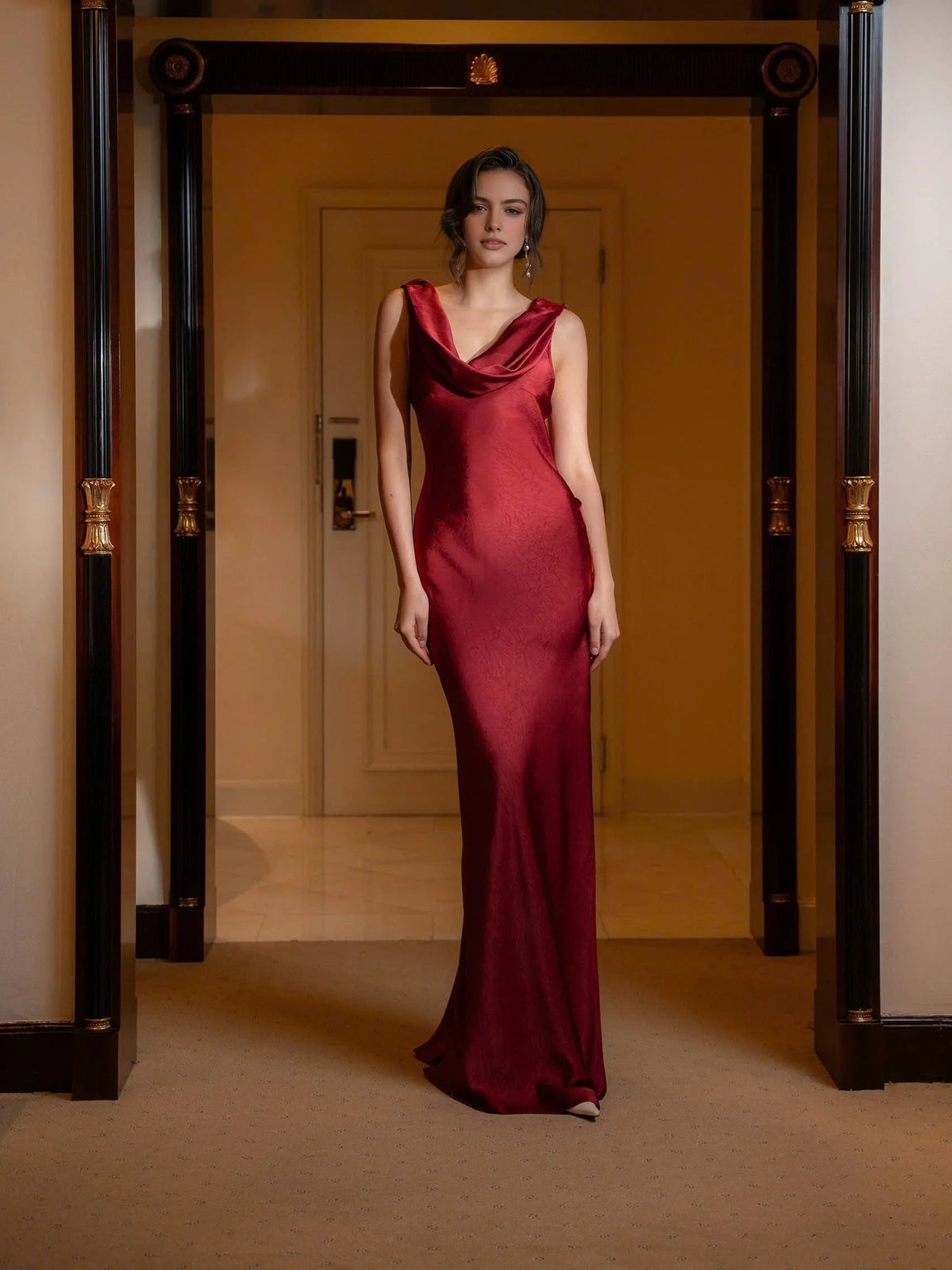 Red satin maxi sheath dress with draped cowl neck and sleeveless fitted silhouette