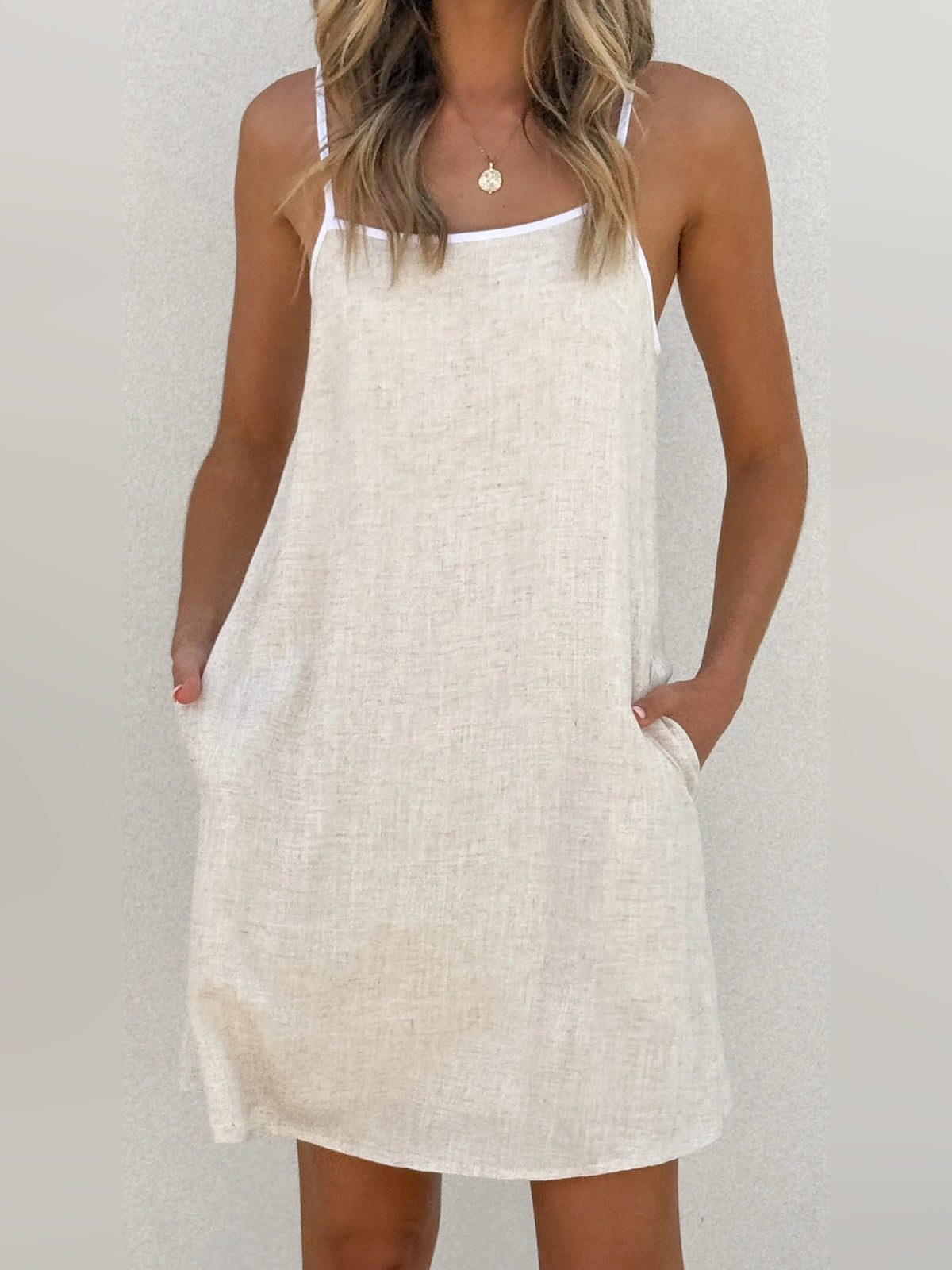 White mini shift dress with square neckline and spaghetti straps
