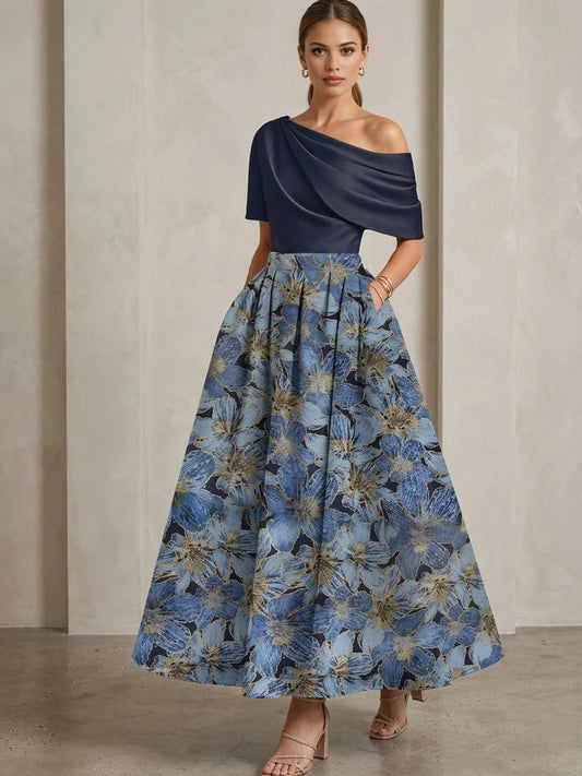 Navy one-shoulder dress with draped bodice and blue floral A-line skirt