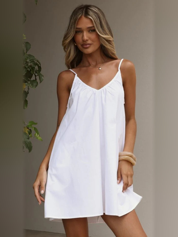 White mini homecoming dress with V-neck and spaghetti straps, gathered bust