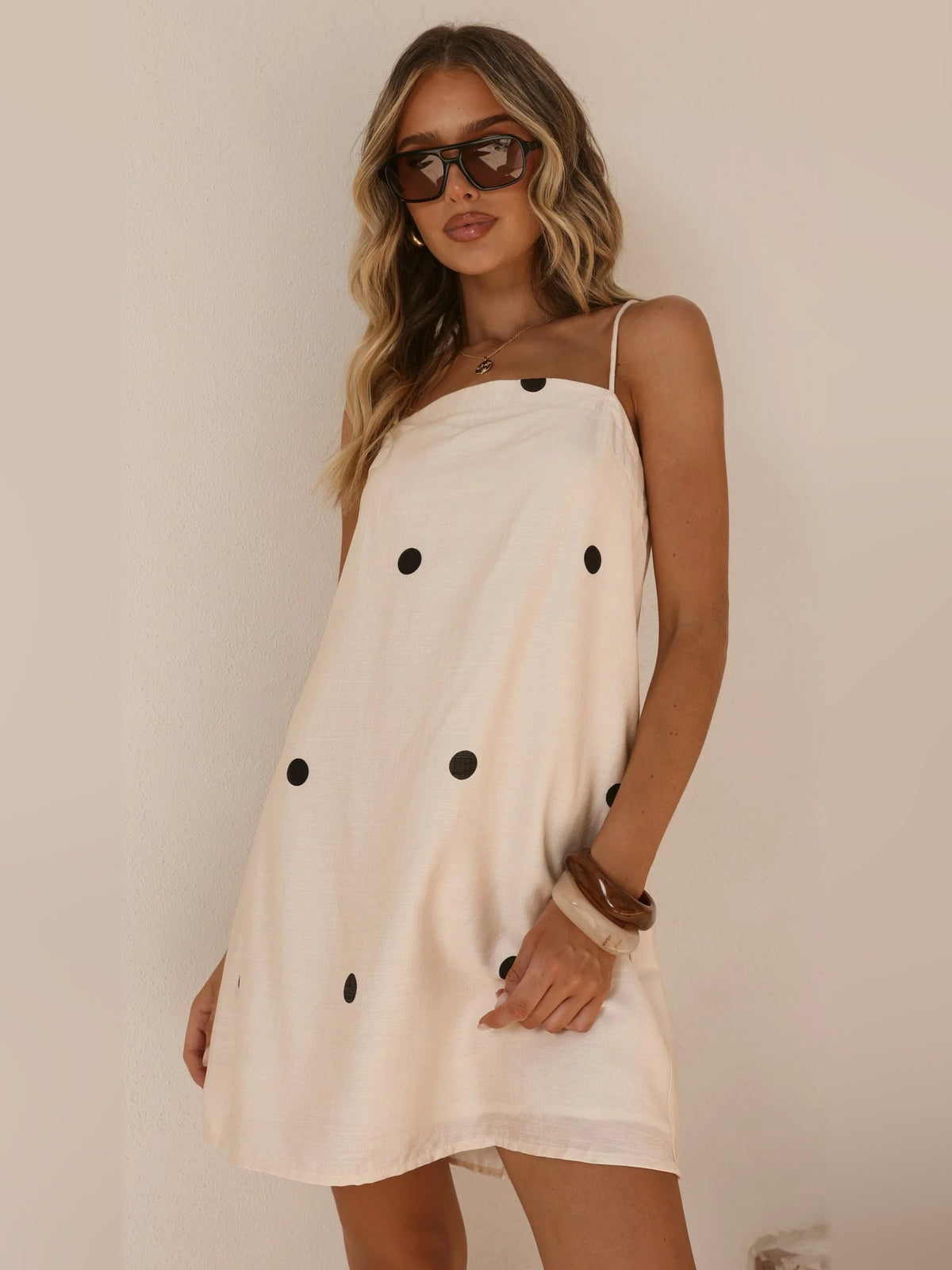 Cream mini dress with black polka dots, spaghetti straps, square neckline