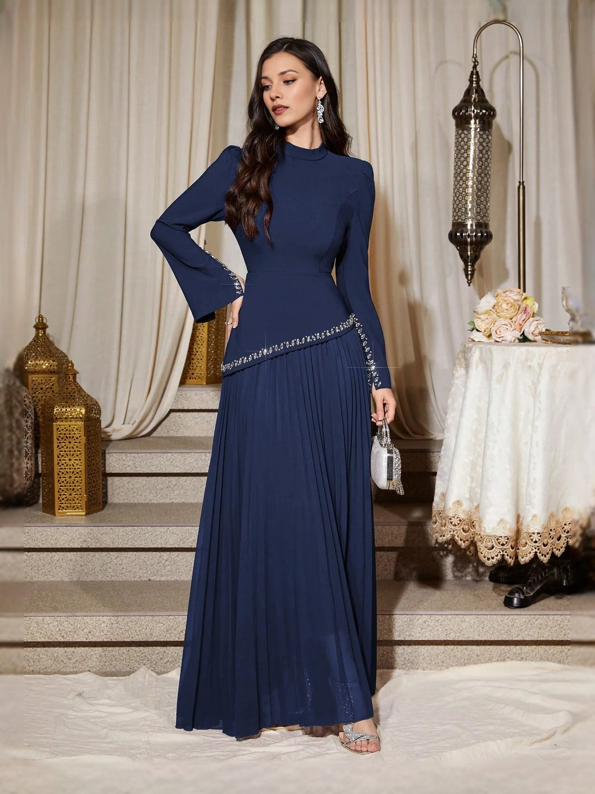 Navy high-neck pleated maxi dress with long sleeves and rhinestone waistband
