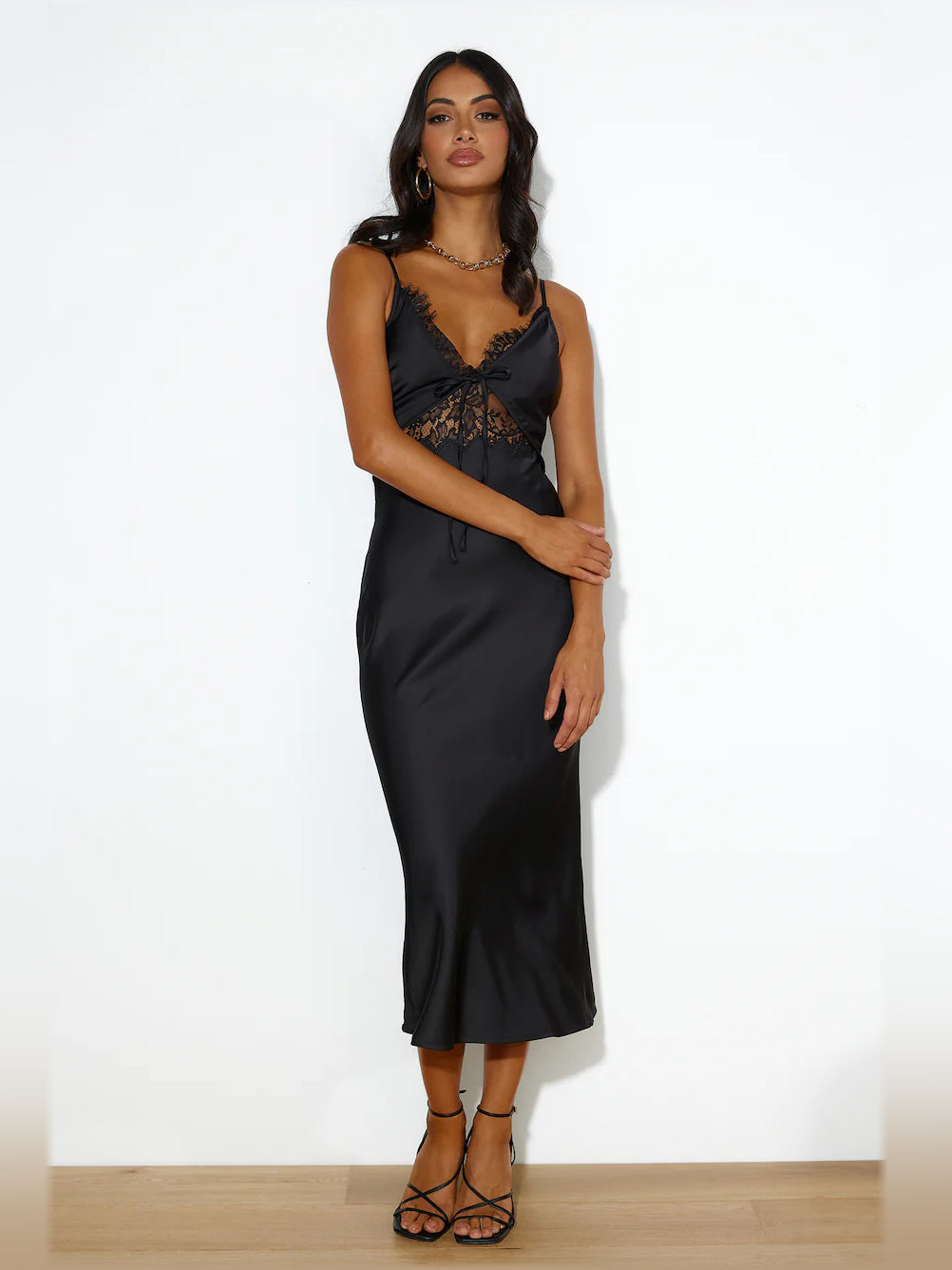 Black midi formal dress with lace-up bodice, scalloped V neckline, and spaghetti straps