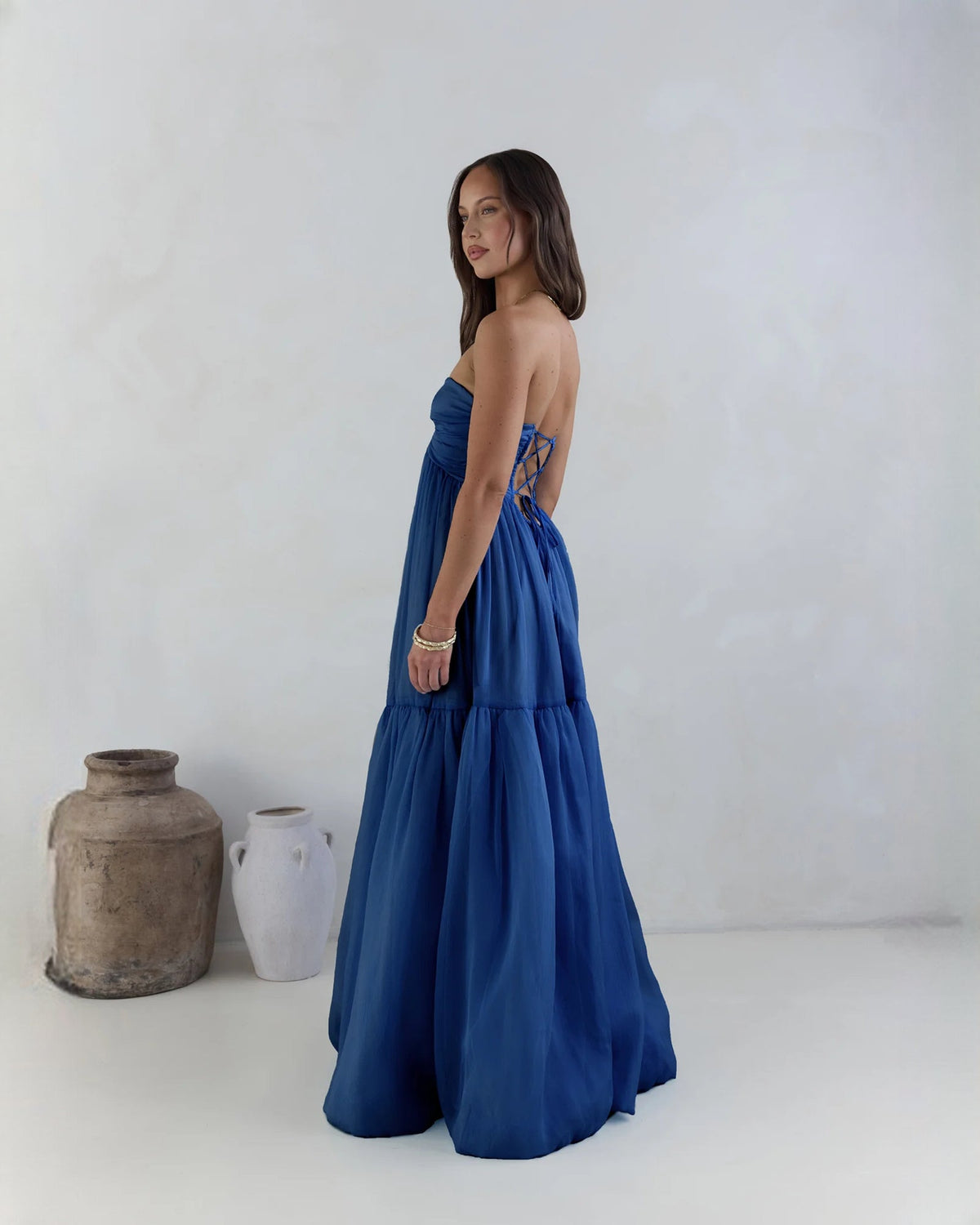 Navy strapless satin tiered maxi dress with ruched bust and soft A-line flare