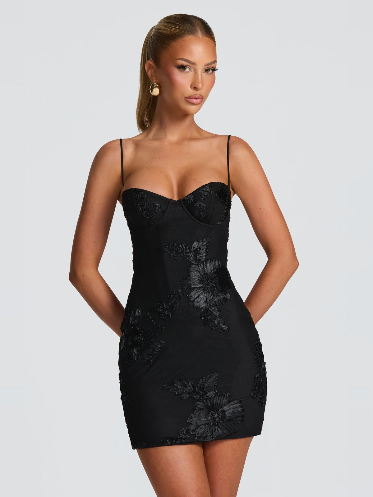 Black mini dress with spaghetti straps, sweetheart neckline, floral embroidery