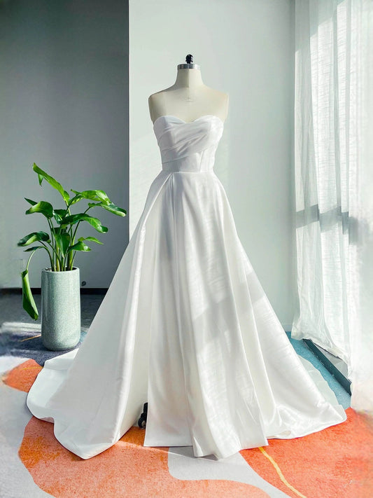 White strapless sweetheart A-line satin wedding dress with draped bodice, floor length
