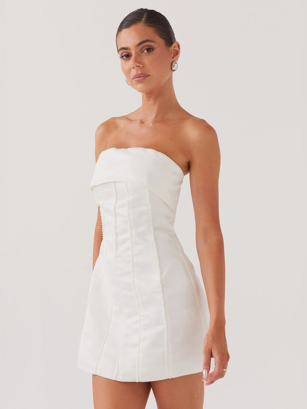 Pearl strapless mini homecoming dress with fitted corset seams and side slit