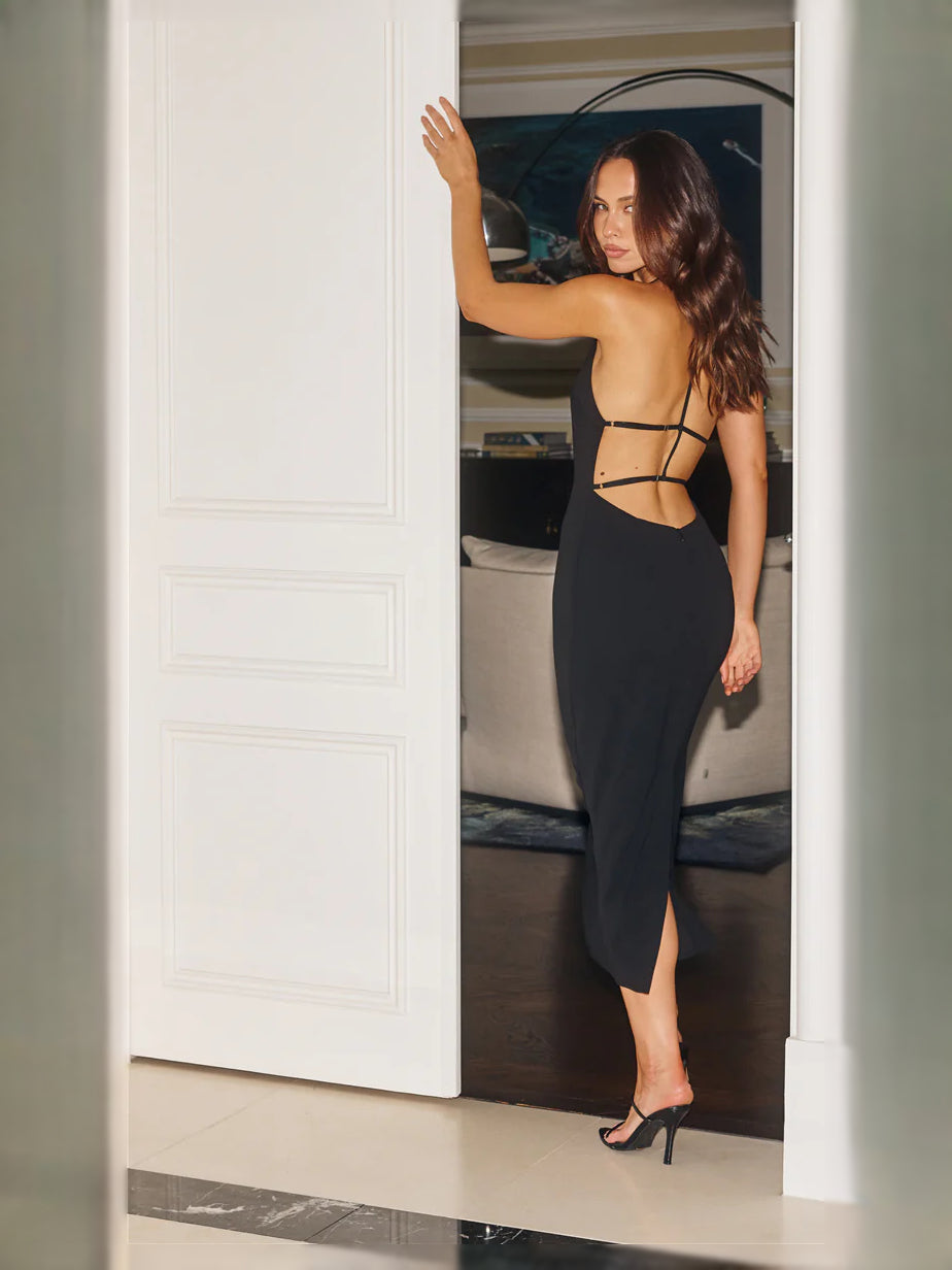 Black midi formal dress with halter straps and open back, side view
