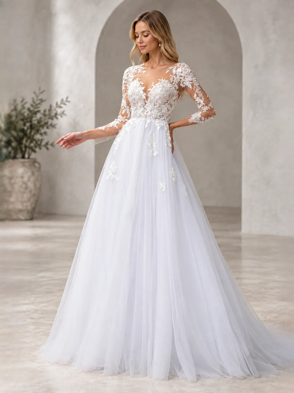 White V-neck A-line wedding dress with long lace sleeves and layered floral applique bodice