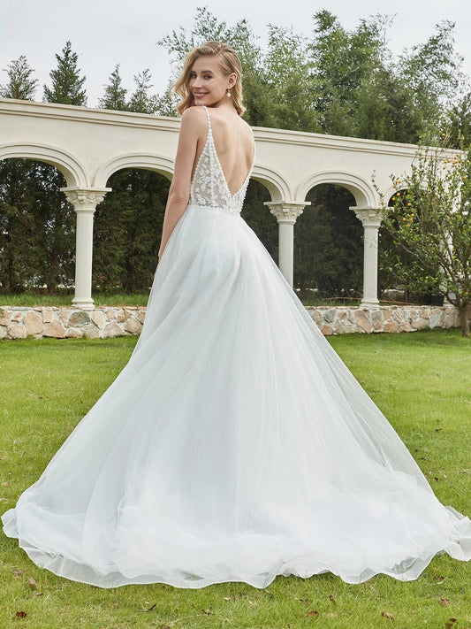 Ivory A-line tulle wedding dress with corset bodice, floral applique, and V-neck straps.