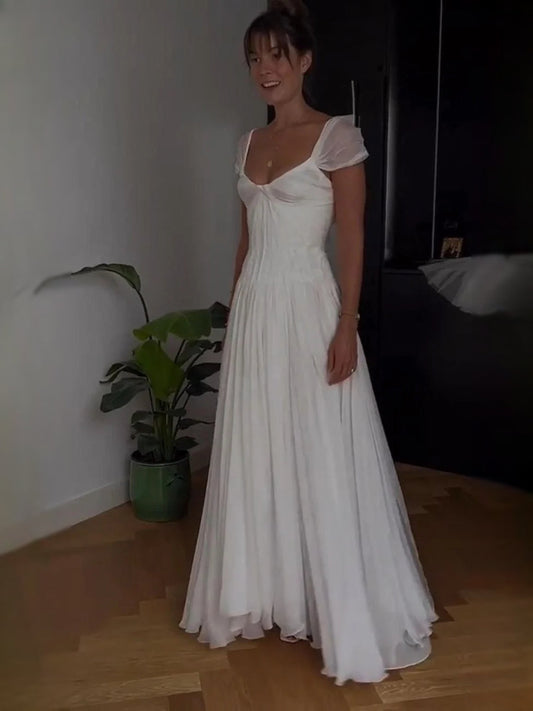 Ivory A-line wedding dress with sweetheart neckline, ruched bodice, short puff sleeves