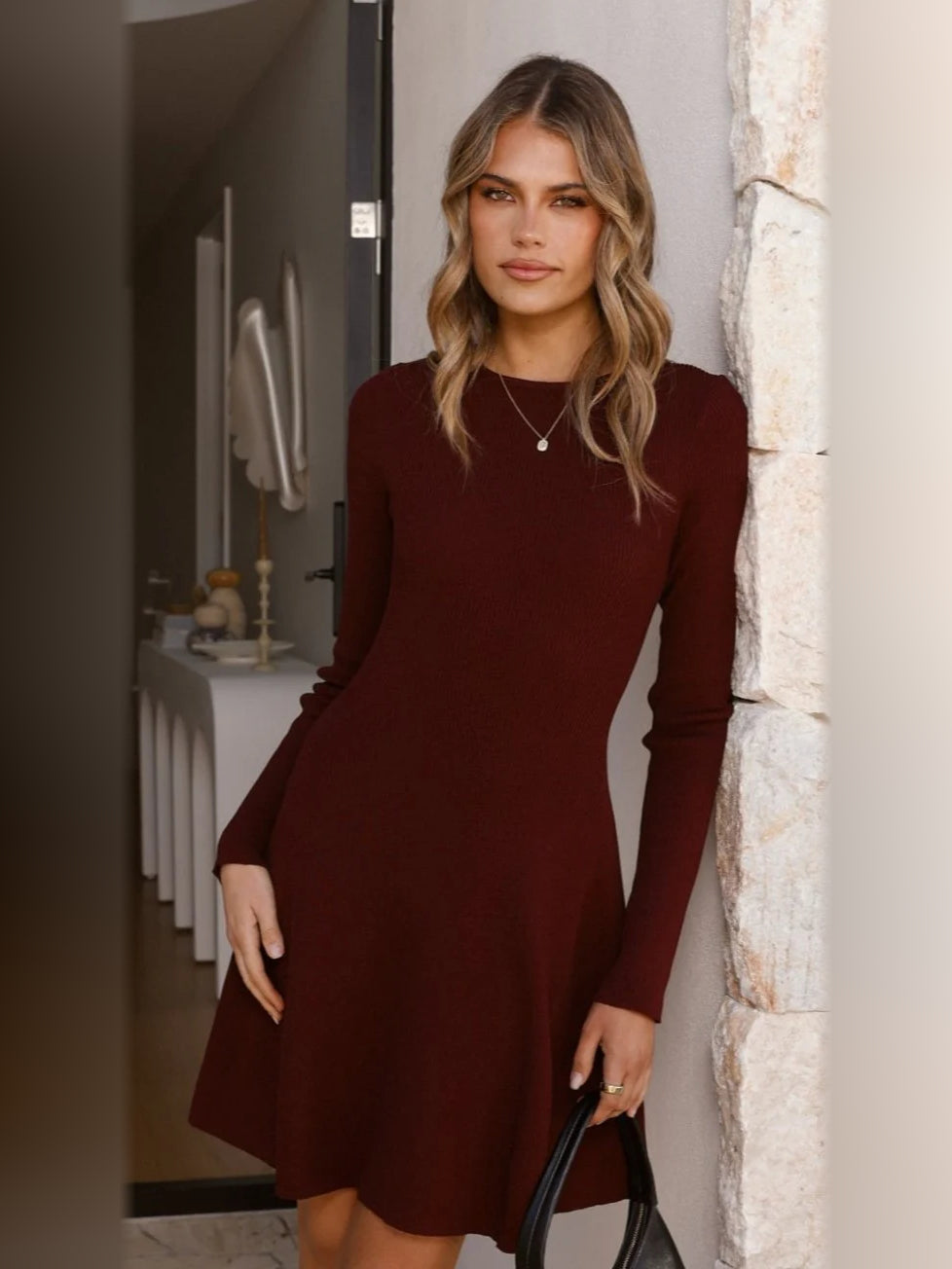 Burgundy mini dress with long sleeves and fitted waist, flared skirt hem