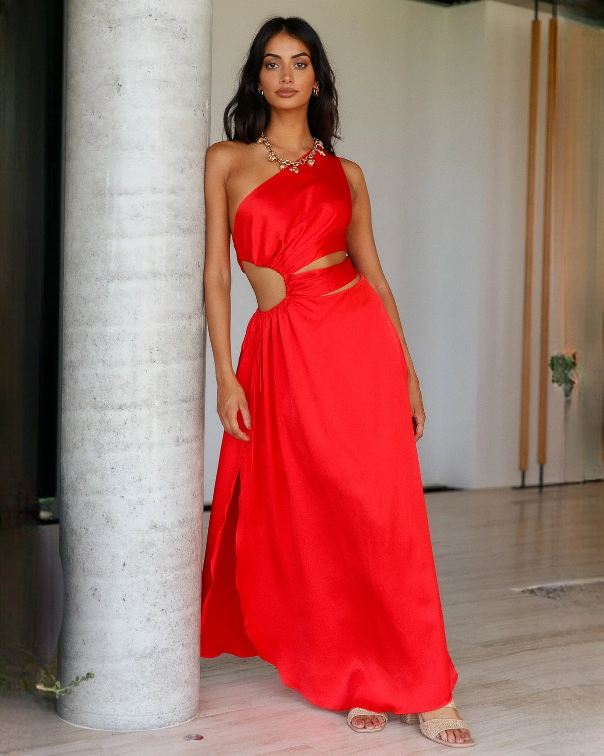 Red satin sleeveless A-line maxi bridesmaid dress with draped waist knot and thigh slit.