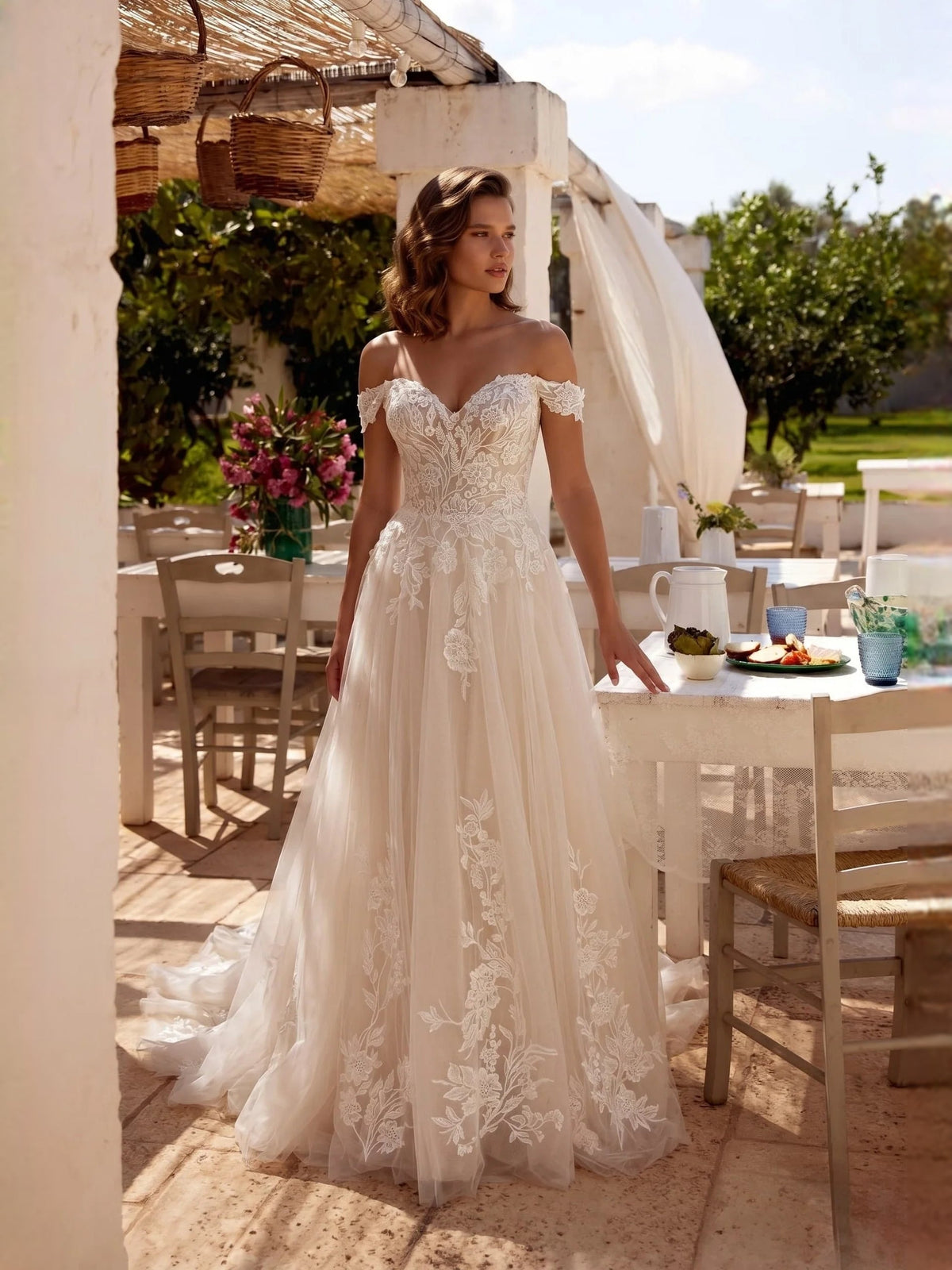 Ivory off-shoulder A-line wedding dress with floral lace appliques and tulle skirt