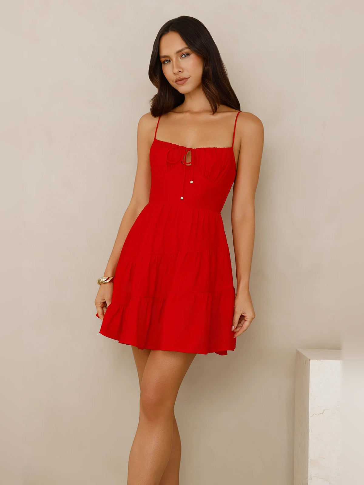 Red mini homecoming dress with spaghetti straps, square neckline, and tiered flared skirt
