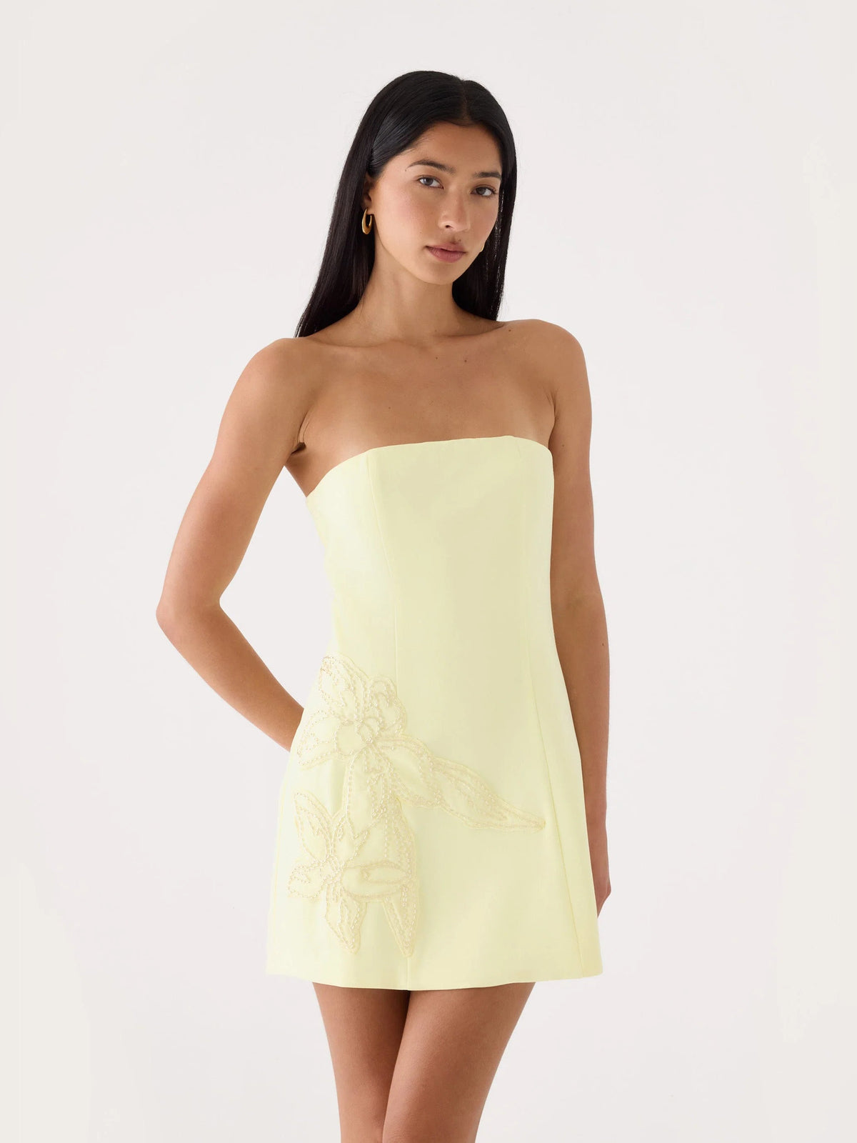 Yellow strapless mini dress with embroidered floral detail on the bodice and skirt