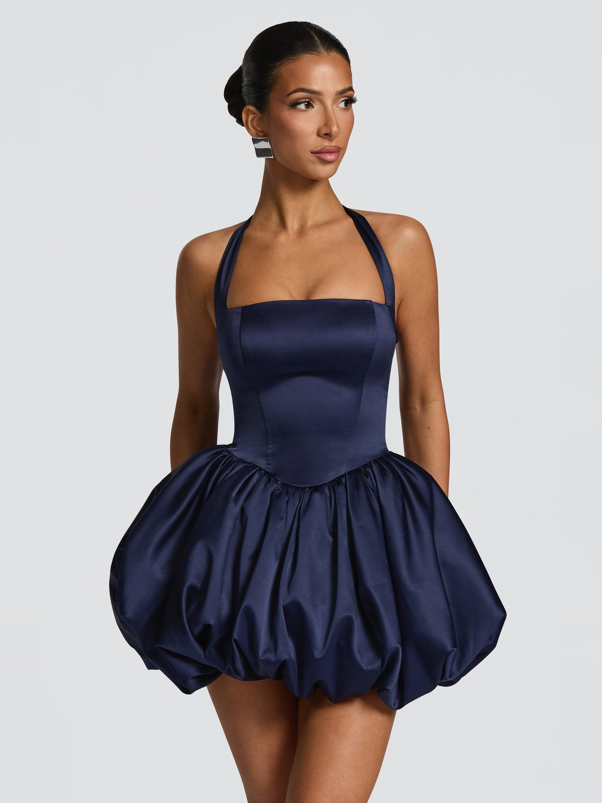 Navy mini dress with halter straps, fitted bodice, and puffed skirt