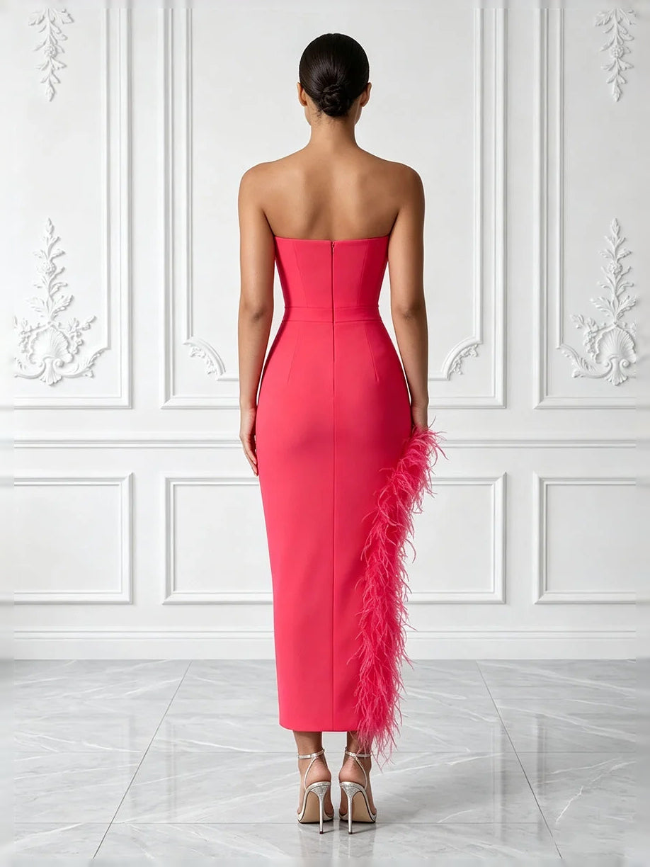 Hot pink strapless corset midi prom dress, back view, side-slit with feather trim
