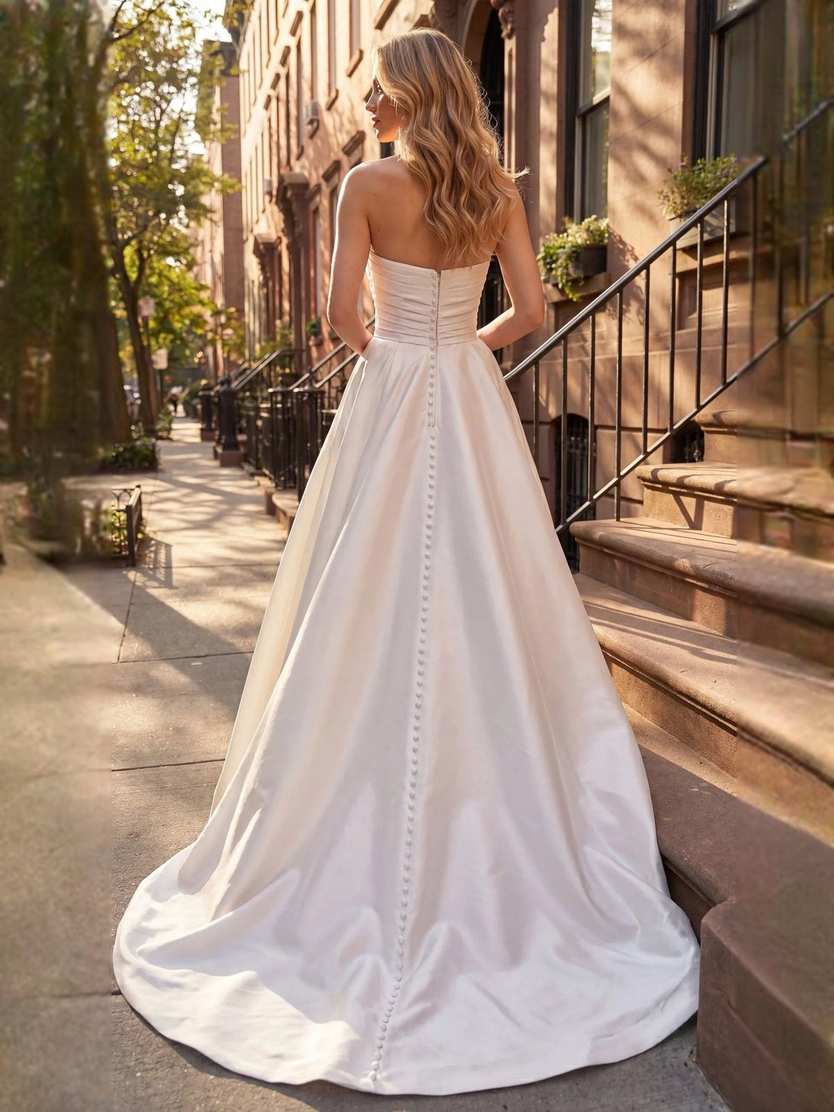 Ivory satin wedding dress with sweetheart neckline, ruched bodice and beaded detail, sleeveless