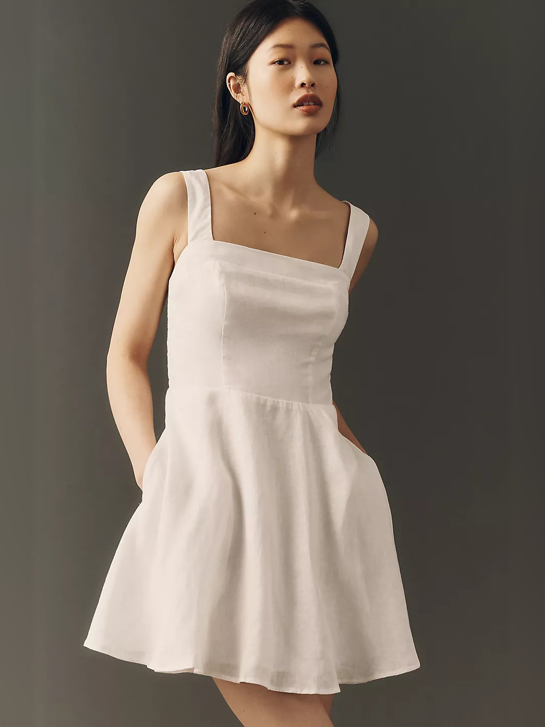 White square-neck sleeveless mini dress with fitted bodice and flared skirt